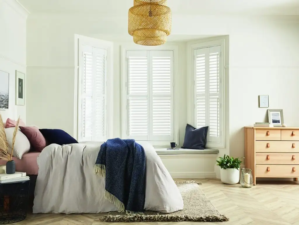 Bedroom with white plantation shutters